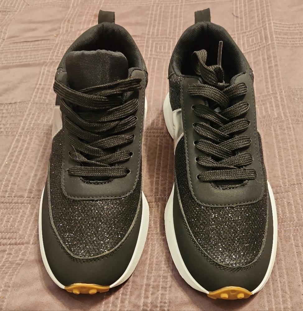 Black sneakers with white and silver trim